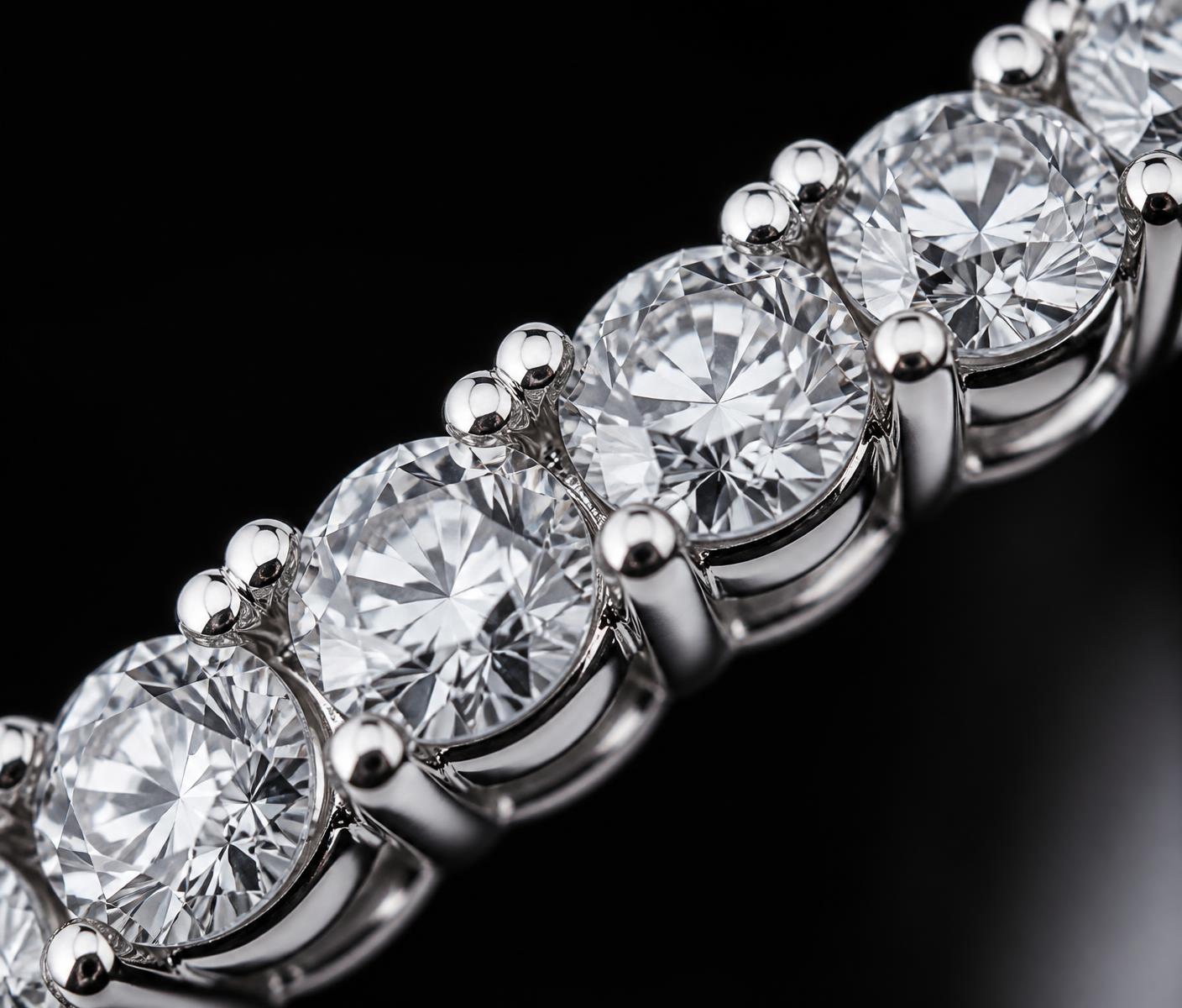 Macro close-up of hand-set diamond tennis prongs